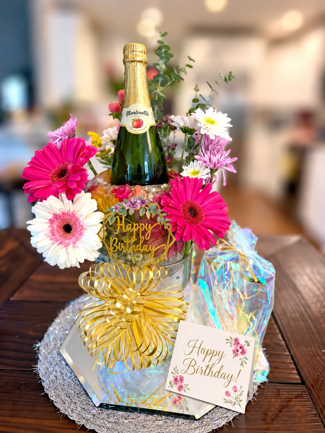 Celebration Bloom birthday presentation with sparkling cider and bright pink flowers