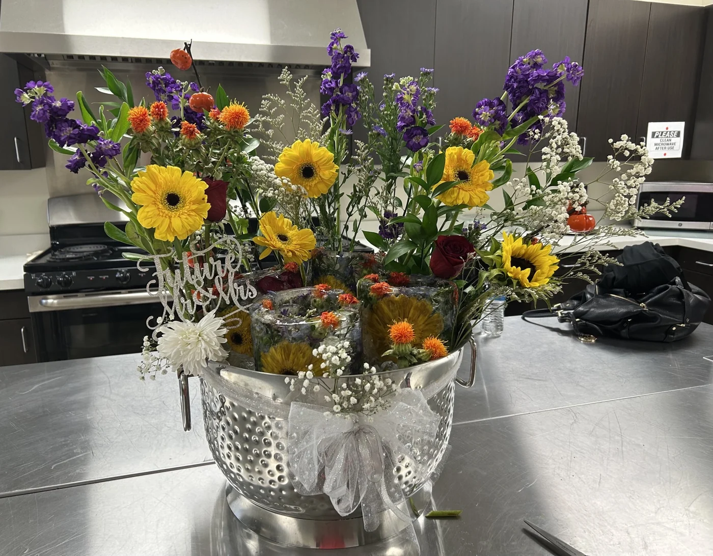 Floral ice display with colorful flowers and a Future Mr and Mrs topper at a bridal shower