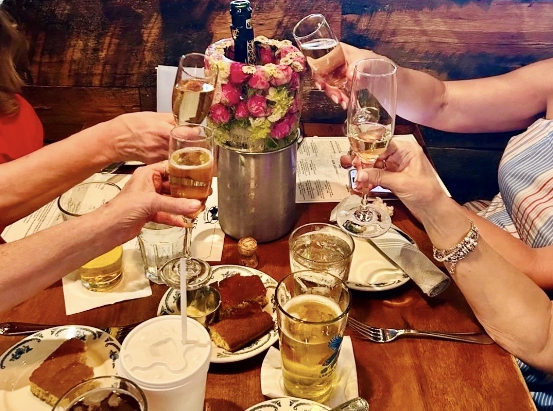 Guests raising glasses around a floral ice chiller