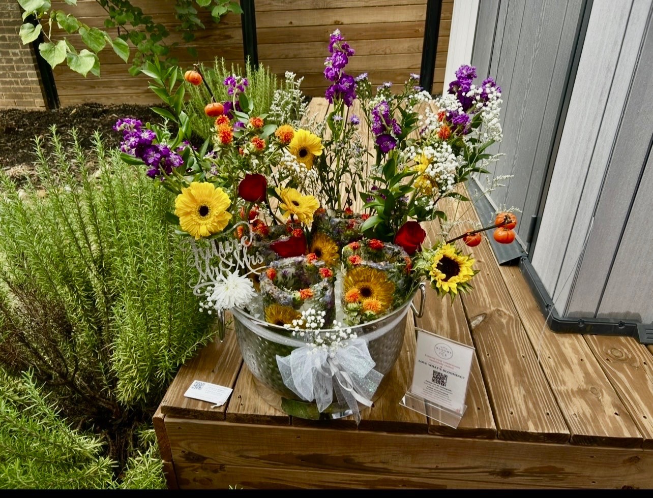 Outdoor floral ice display with colorful flowers and celebration details